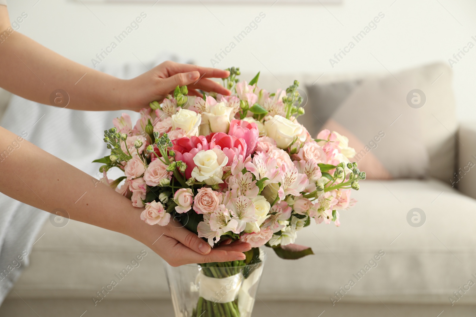 Photo of Woman with beautiful bouquet of fresh flowers at home, closeup