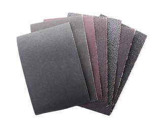 Many sheets of sandpaper isolated on white, top view