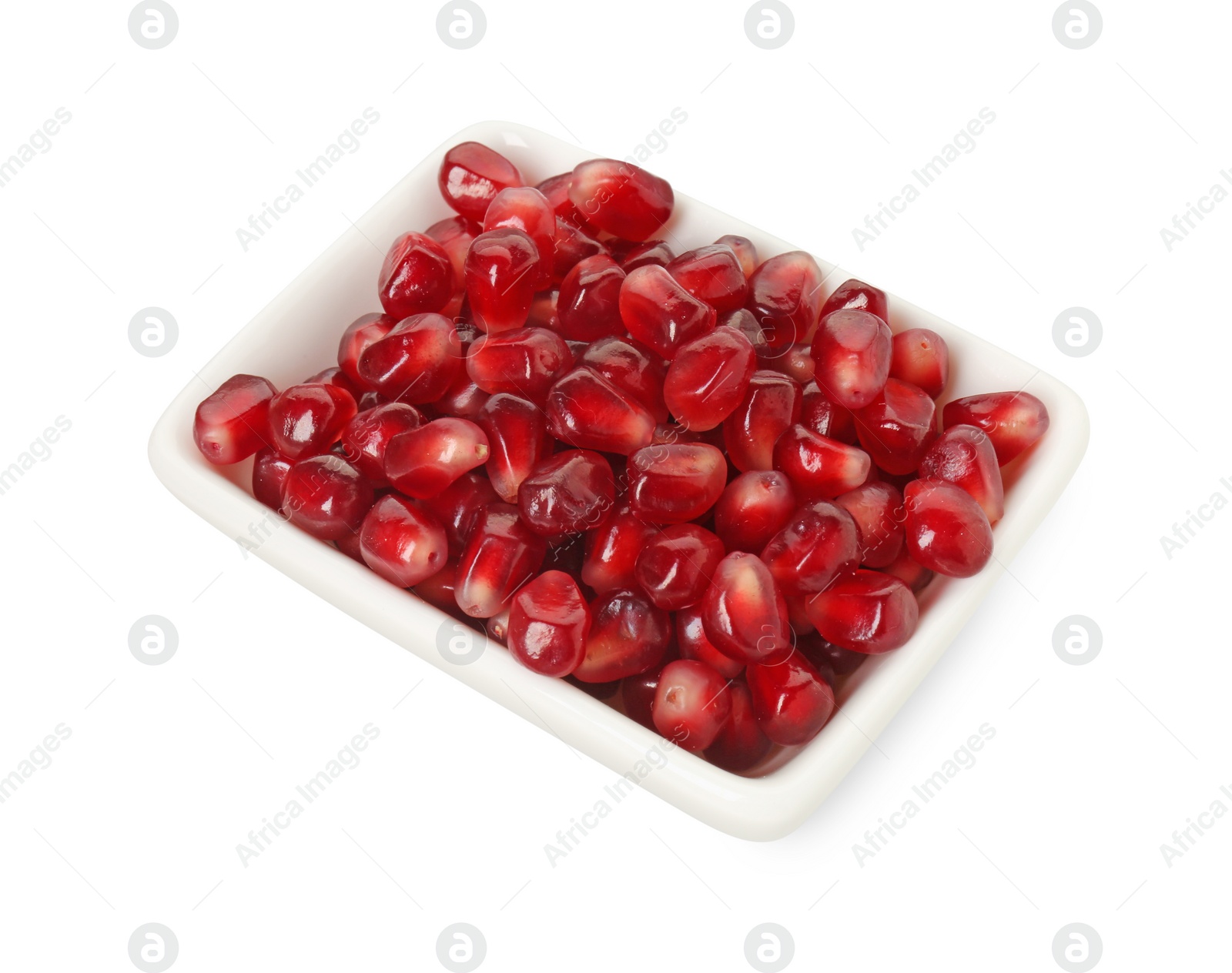 Photo of Ripe juicy pomegranate grains in bowl isolated on white