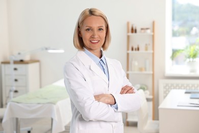 Portrait of happy dermatologist in modern clinic