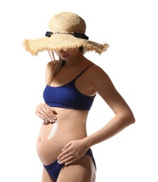Photo of Pregnant woman applying sun protection cream on her belly against white background