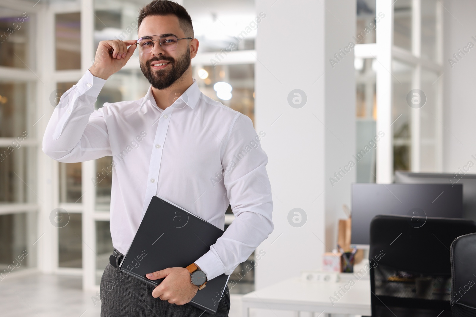 Photo of Portrait of smiling man with folder in office, space for text. Lawyer, businessman, accountant or manager