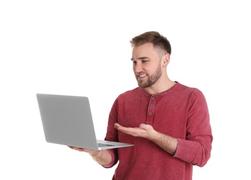 Young man using video chat on laptop against white background