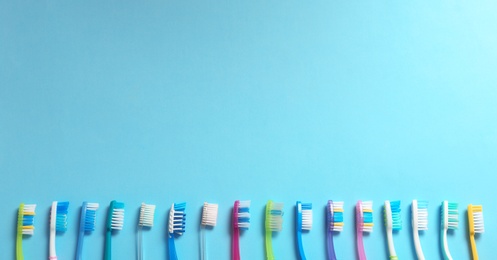 Photo of Flat lay composition with toothbrushes on color background. Space for text