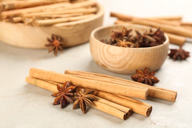 Photo of Aromatic cinnamon sticks and anise on light table