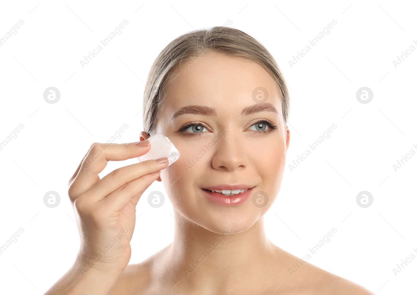 Photo of Young woman with ice cube on white background. Skin care