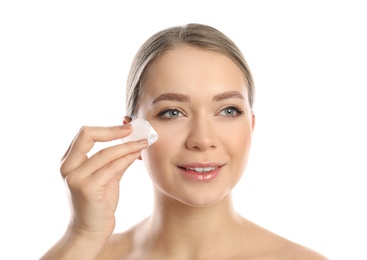 Photo of Young woman with ice cube on white background. Skin care