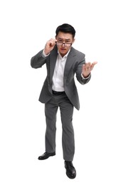 Photo of Angry businessman in suit wearing glasses on white background, low angle view