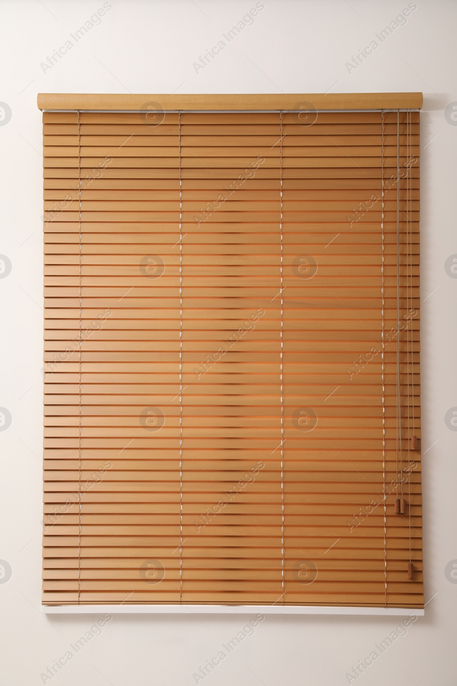 Photo of Modern window with closed wooden blinds indoors