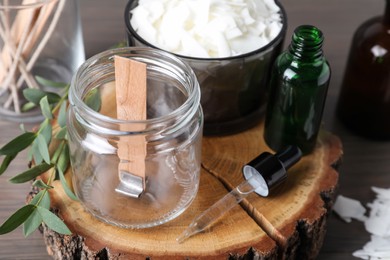 Photo of Ingredients for homemade candle on wooden stump