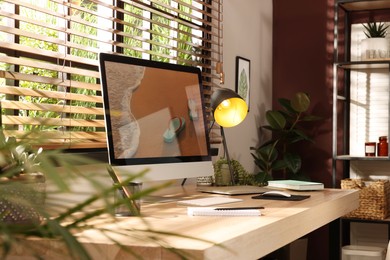 Photo of Comfortable workplace near window in room. Interior design