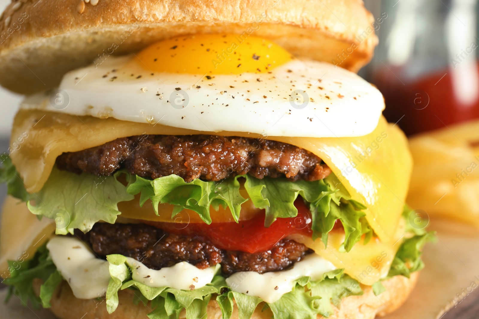 Photo of Closeup view of tasty burger with fried egg