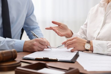 Lawyers working with documents at table in office, closeup