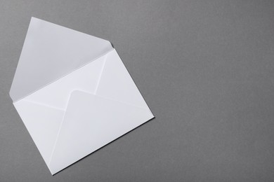 Letter envelope on grey background, top view. Space for text