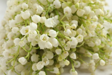 Beautiful lily of the valley bouquet as background, closeup