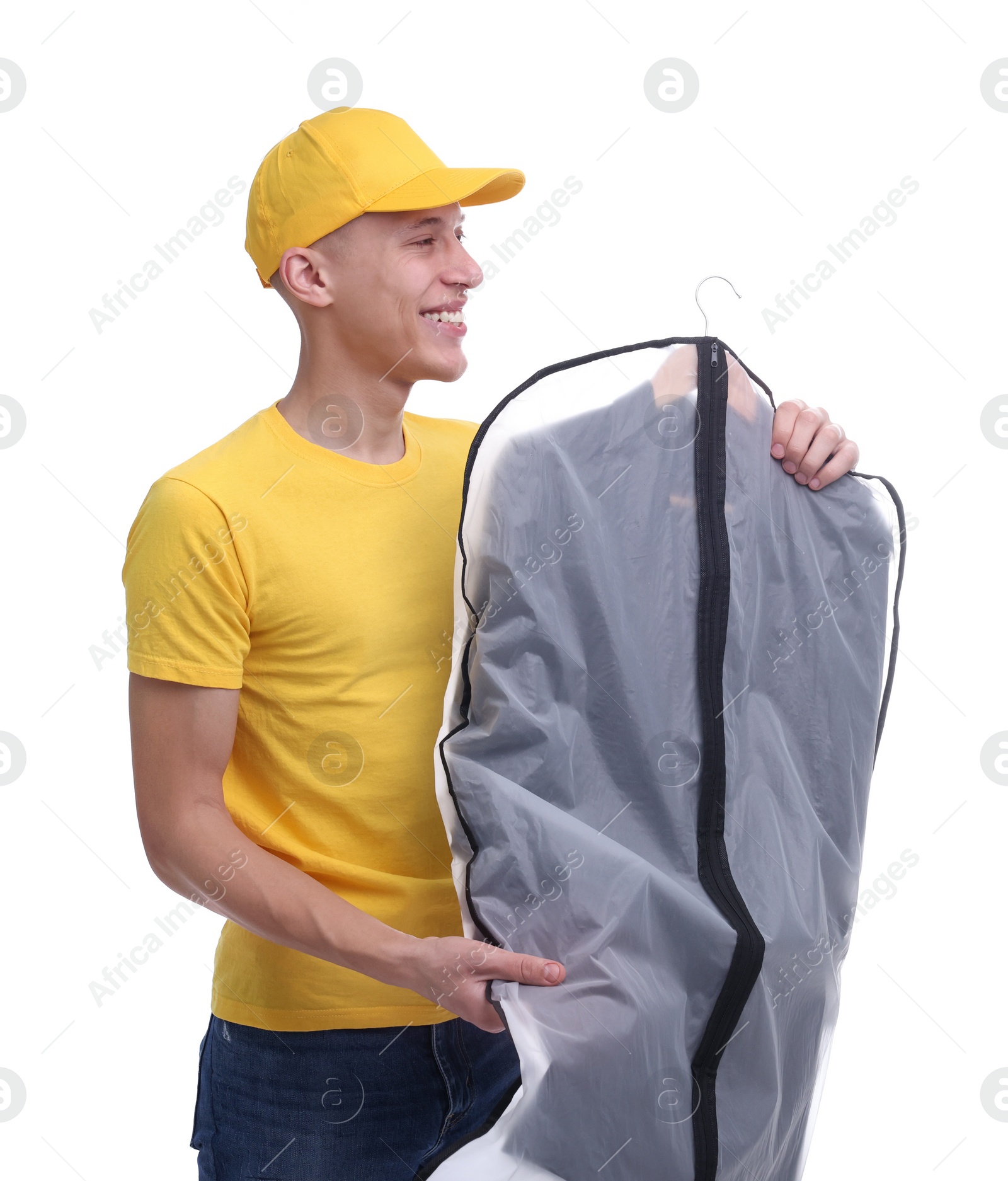 Photo of Dry-cleaning delivery. Happy courier holding garment cover with clothes on white background