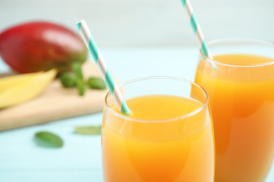 Fresh delicious mango drink on table, closeup