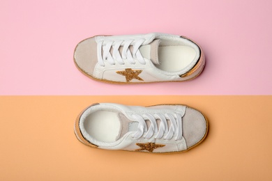 Photo of Stylish new shoes on color background, top view