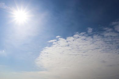 Sun and white clouds in blue sky outdoors