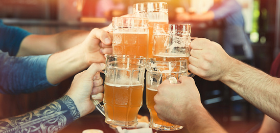 Image of Group of friends toasting with beer in pub, closeup. Banner design