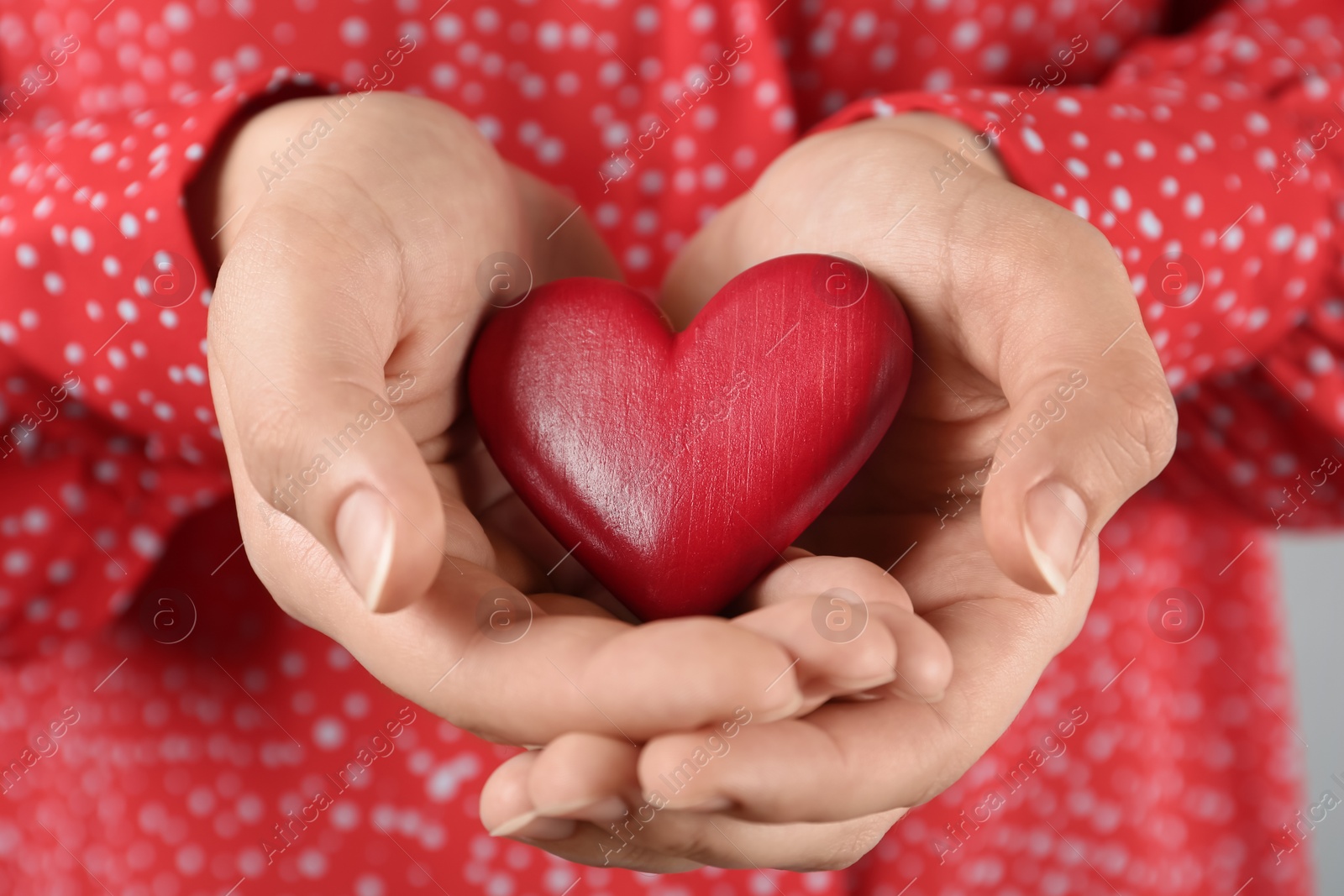 Photo of Woman holding decorative red wooden heart, closeup. Happy Valentine's Day