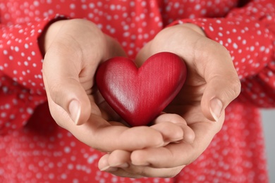 Woman holding decorative red wooden heart, closeup. Happy Valentine's Day