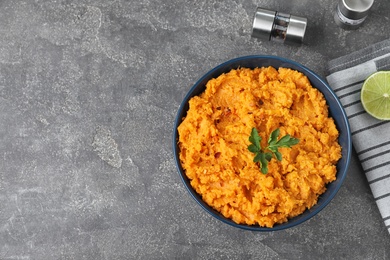 Photo of Flat lay composition with mashed sweet potatoes on grey background, space for text