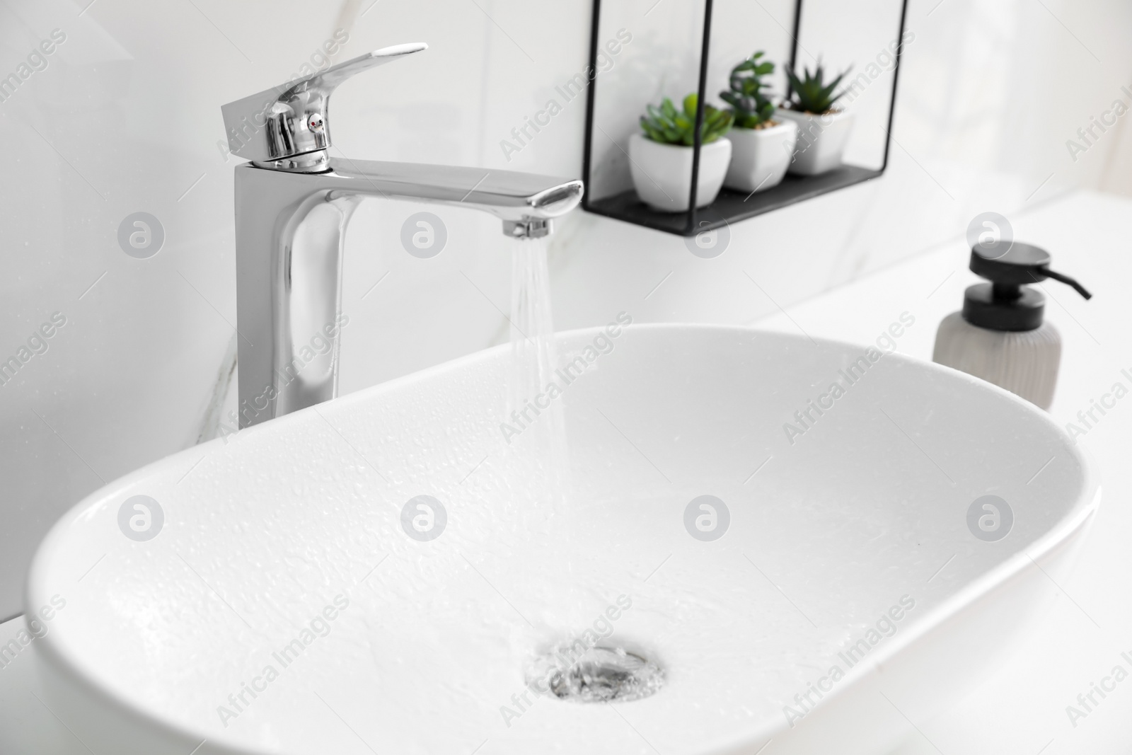 Photo of Stylish vessel sink on bathroom counter. Interior design