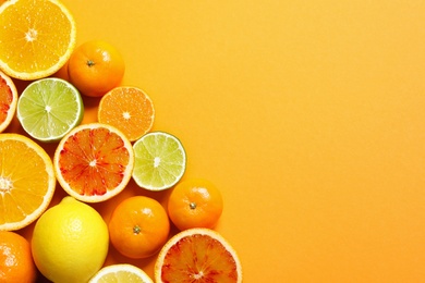 Photo of Different citrus fruits on color background, flat lay. Space for text