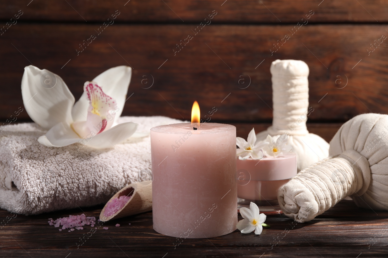 Photo of Composition with spa supplies and flowers on wooden table