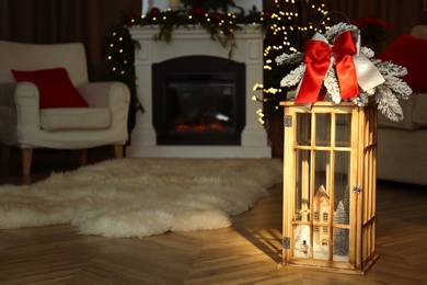 Photo of Beautiful Christmas lantern in room with festive decor