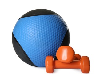 Medicine ball and dumbbells on white background