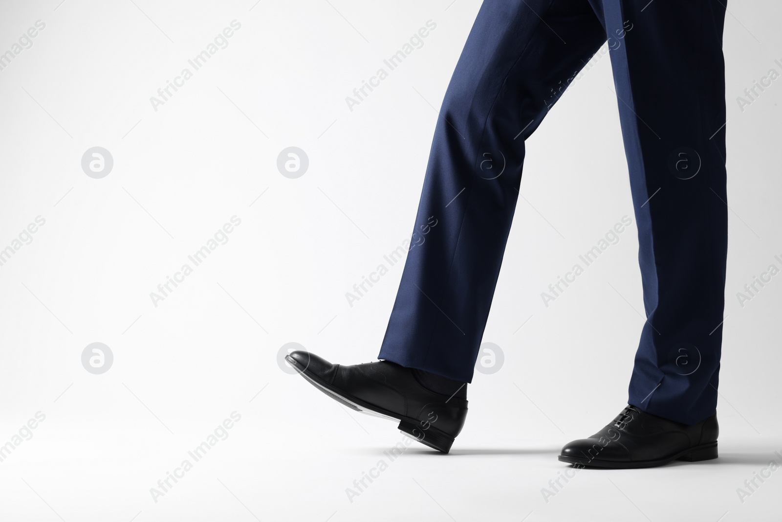 Photo of Businessman in leather shoes on white background, closeup