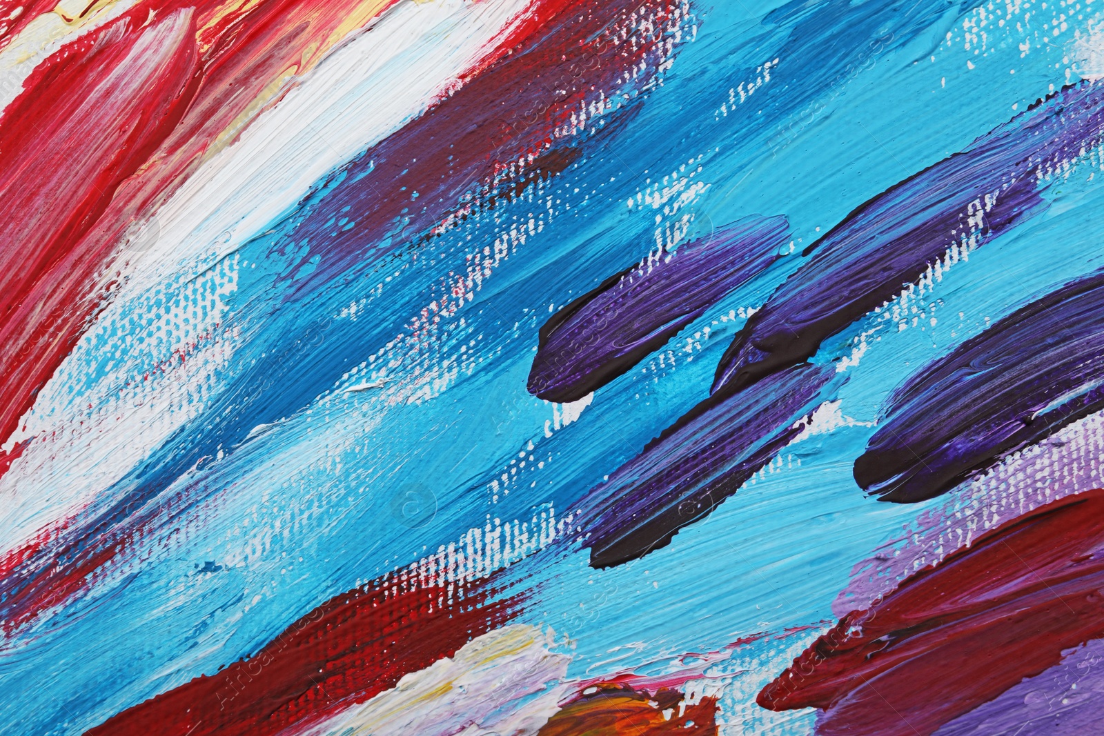 Photo of Beautiful strokes of colorful oil paints on white canvas as background, closeup