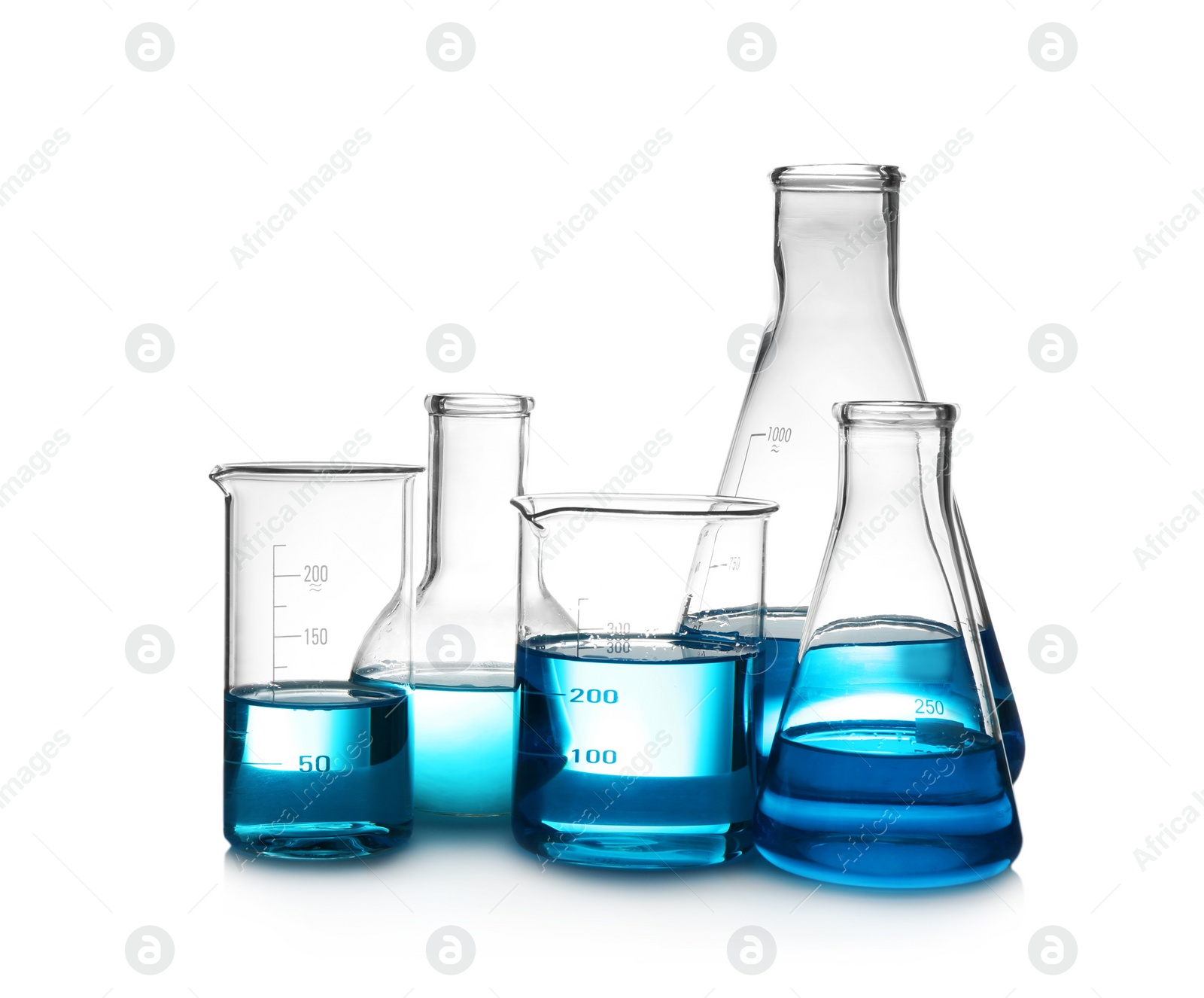 Photo of Laboratory glassware with liquid on table against white background. Chemical analysis