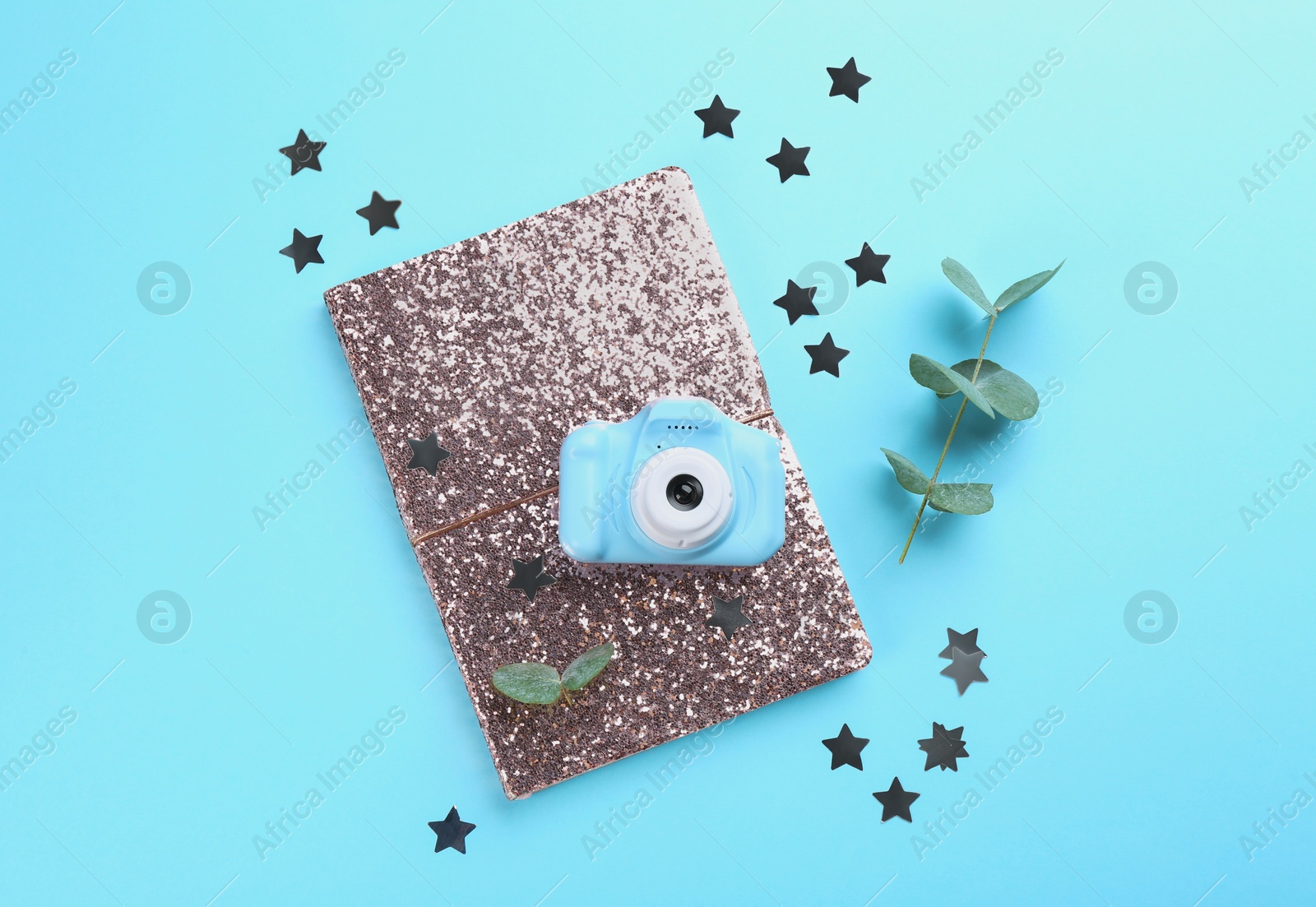 Photo of Flat lay composition with toy camera on light blue background