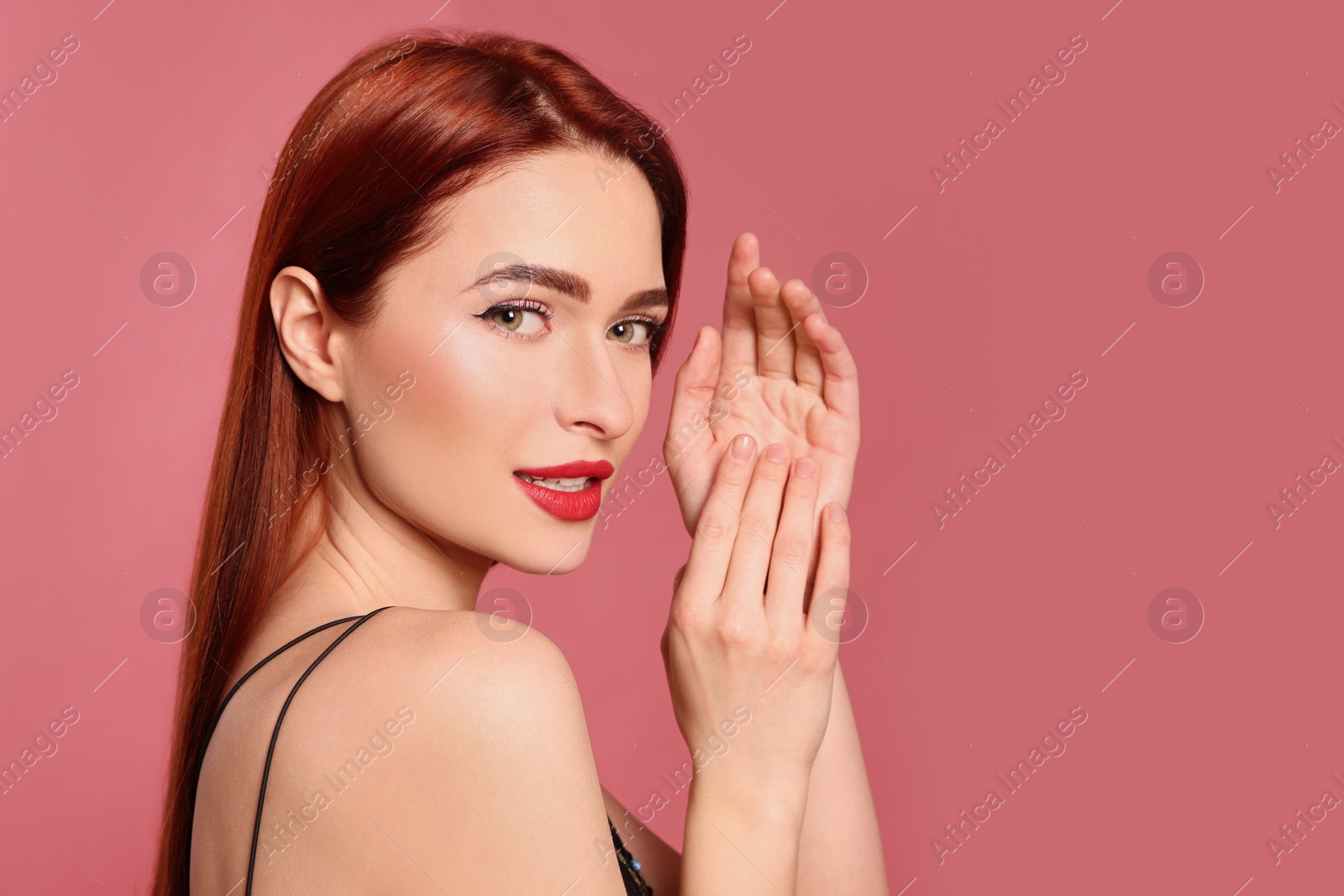 Photo of Beautiful woman with red dyed hair on pink background, space for text
