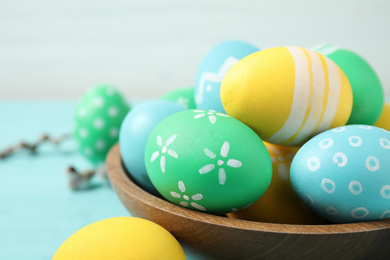 Colorful Easter eggs on light blue table, closeup