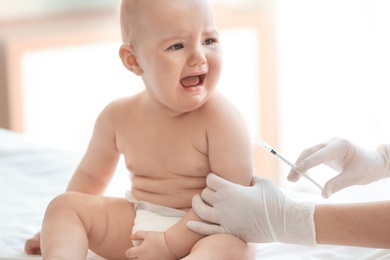 Doctor vaccinating baby in clinic