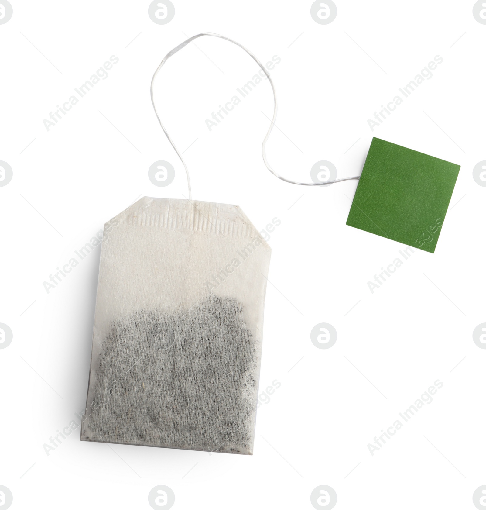 Photo of Paper tea bag with tag isolated on white, top view