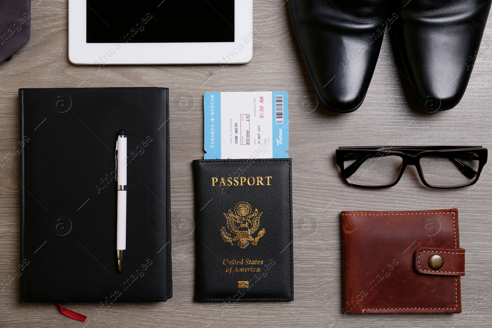 Photo of Business trip stuff on wooden surface, flat lay