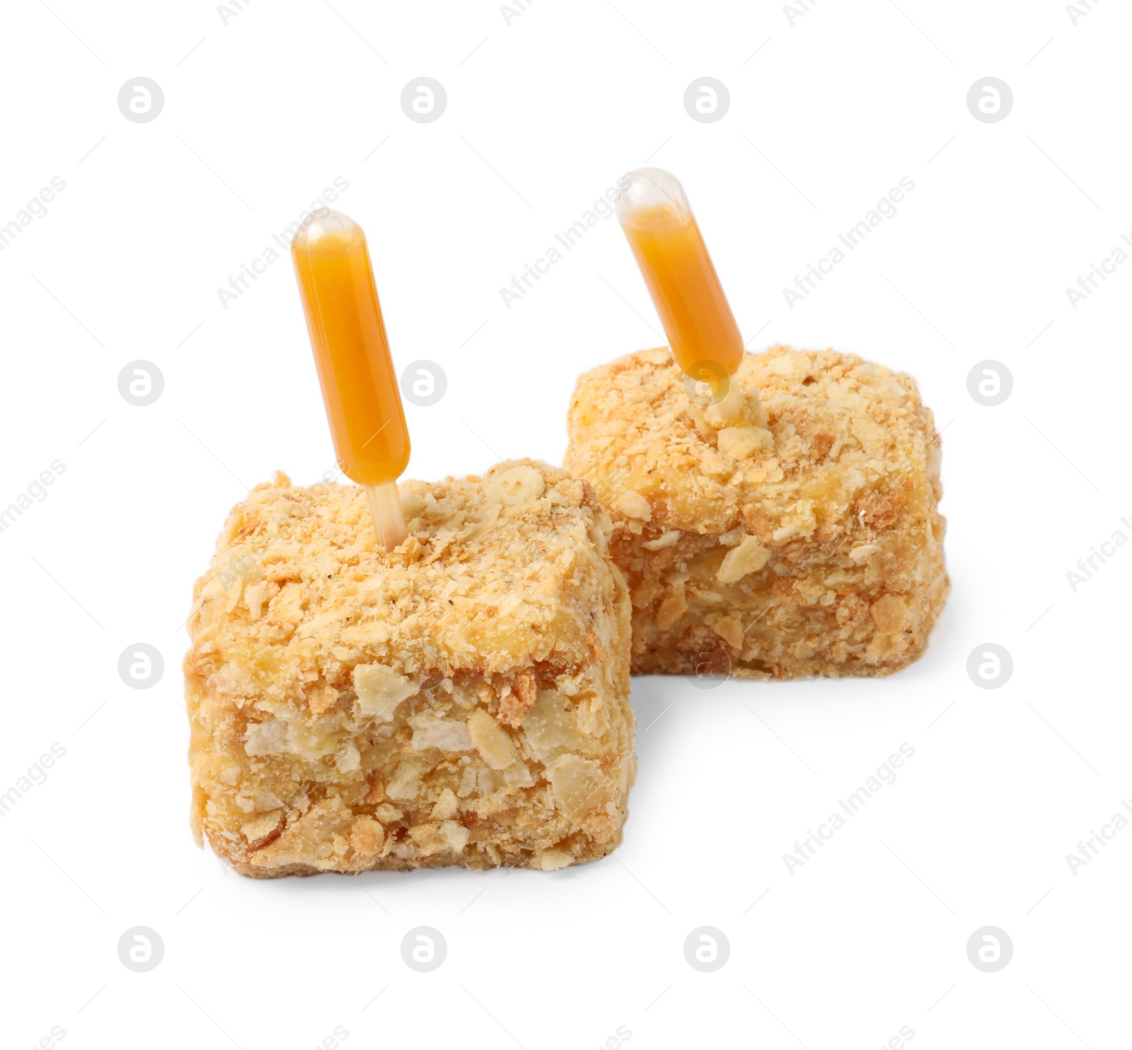 Photo of Pieces of Napoleon cake with jam pipette on white background
