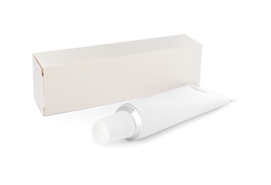 Photo of Blank tube of ointment and package on white background
