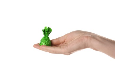 Photo of Woman holding candy in green wrapper isolated on white, closeup