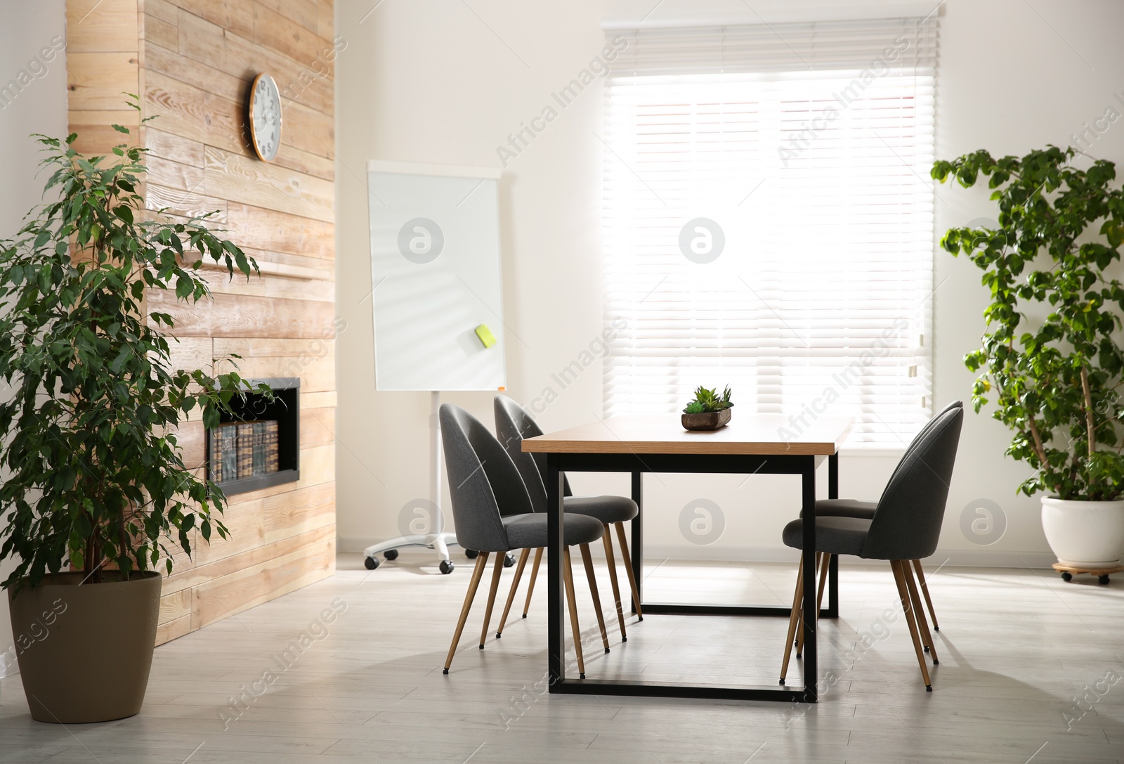 Photo of Modern meeting room interior with large table and chairs