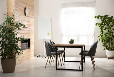 Modern meeting room interior with large table and chairs