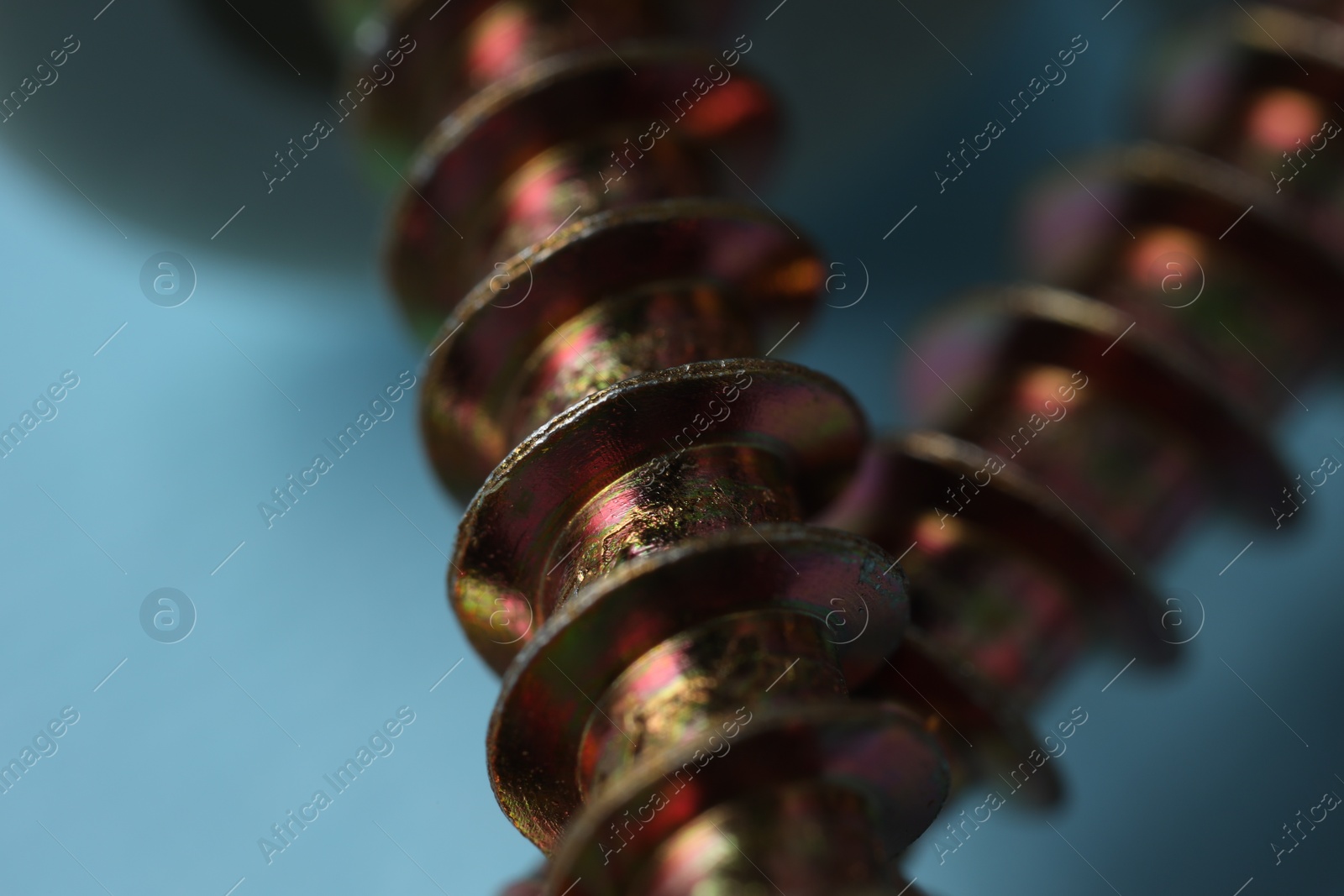 Photo of Closeup view of metal screws on blurred background