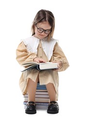 Photo of Cute little girl reading on stack of books against white background