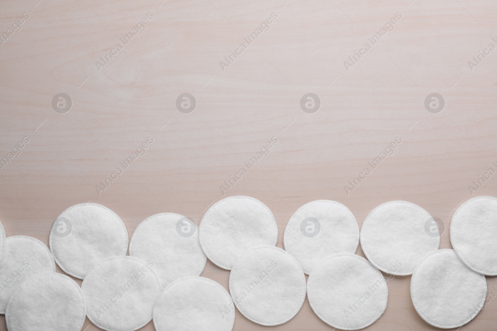 Photo of Many clean cotton pads on wooden table, flat lay. Space for text