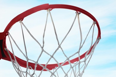 Basketball hoop with net outdoors on sunny day, closeup